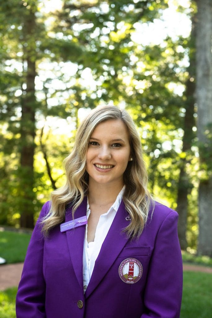 Portrait of Presidential Scholar against wooded background
