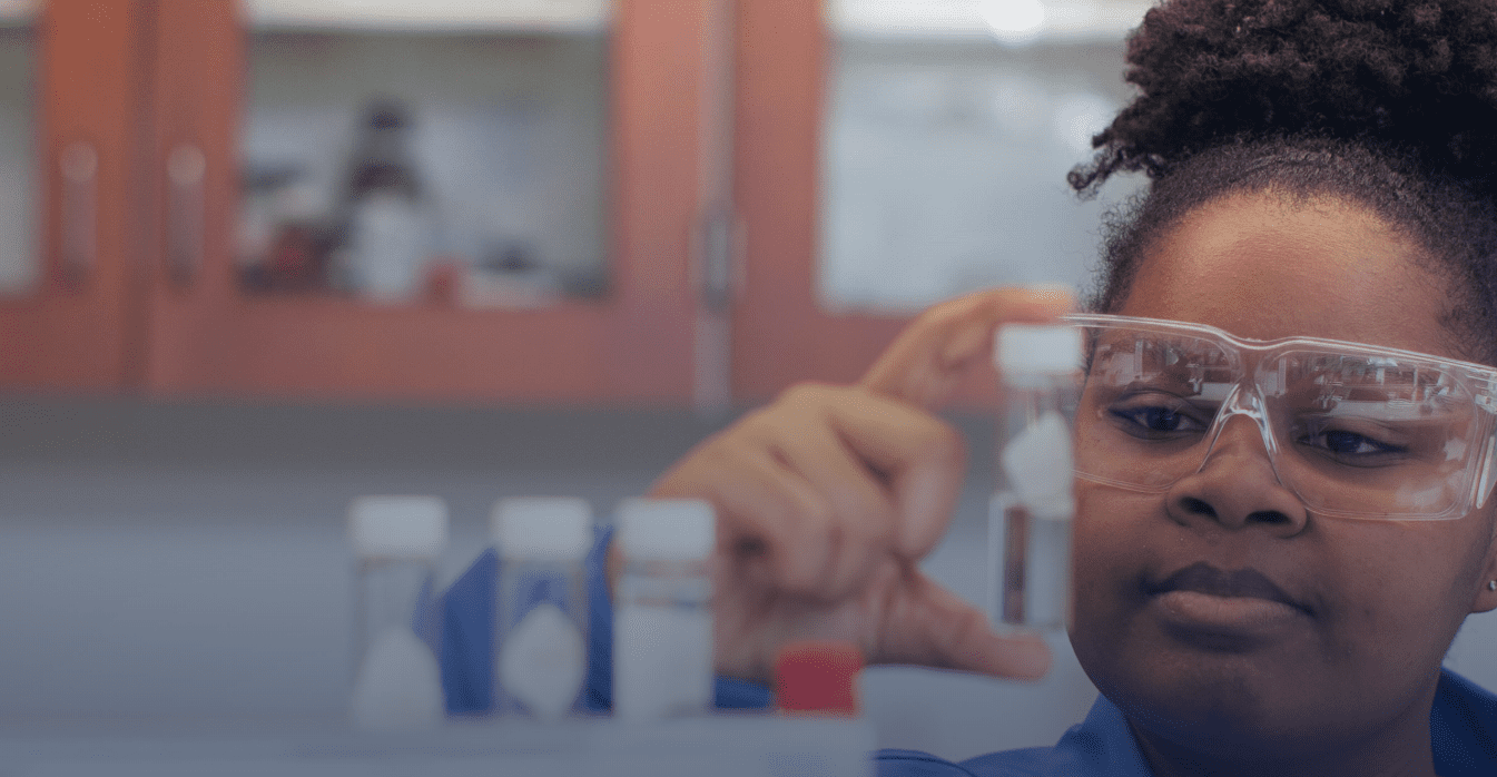 Researcher inspects a laboratory vial.